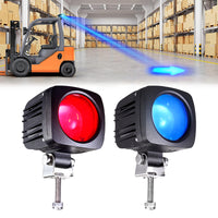 Blue arrow light on ground indicating forklift path