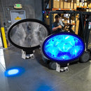 Forklift LED spotlight projecting bright blue beam on ground