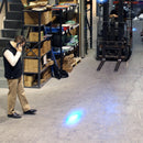 Pedestrian observing blue warning light from forklift