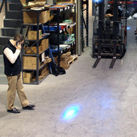Pedestrian observing blue warning light from forklift