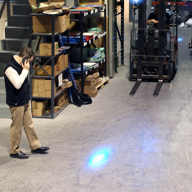 Pedestrian observing blue warning light from forklift