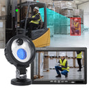 Worker operating forklift with mounted safety monitor
